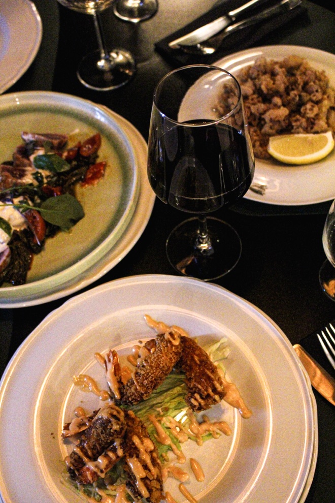 Tavola apparecchiata con piatti e vino da Osteria Annunziata